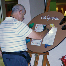 A senior man uses a scanning app on his phone to read a restaurant menu